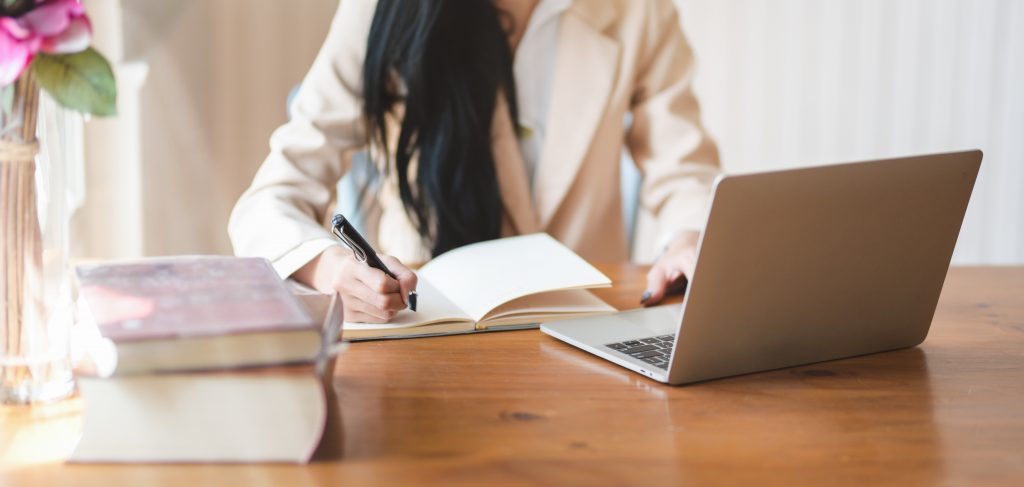 woman-writing-on-notebook